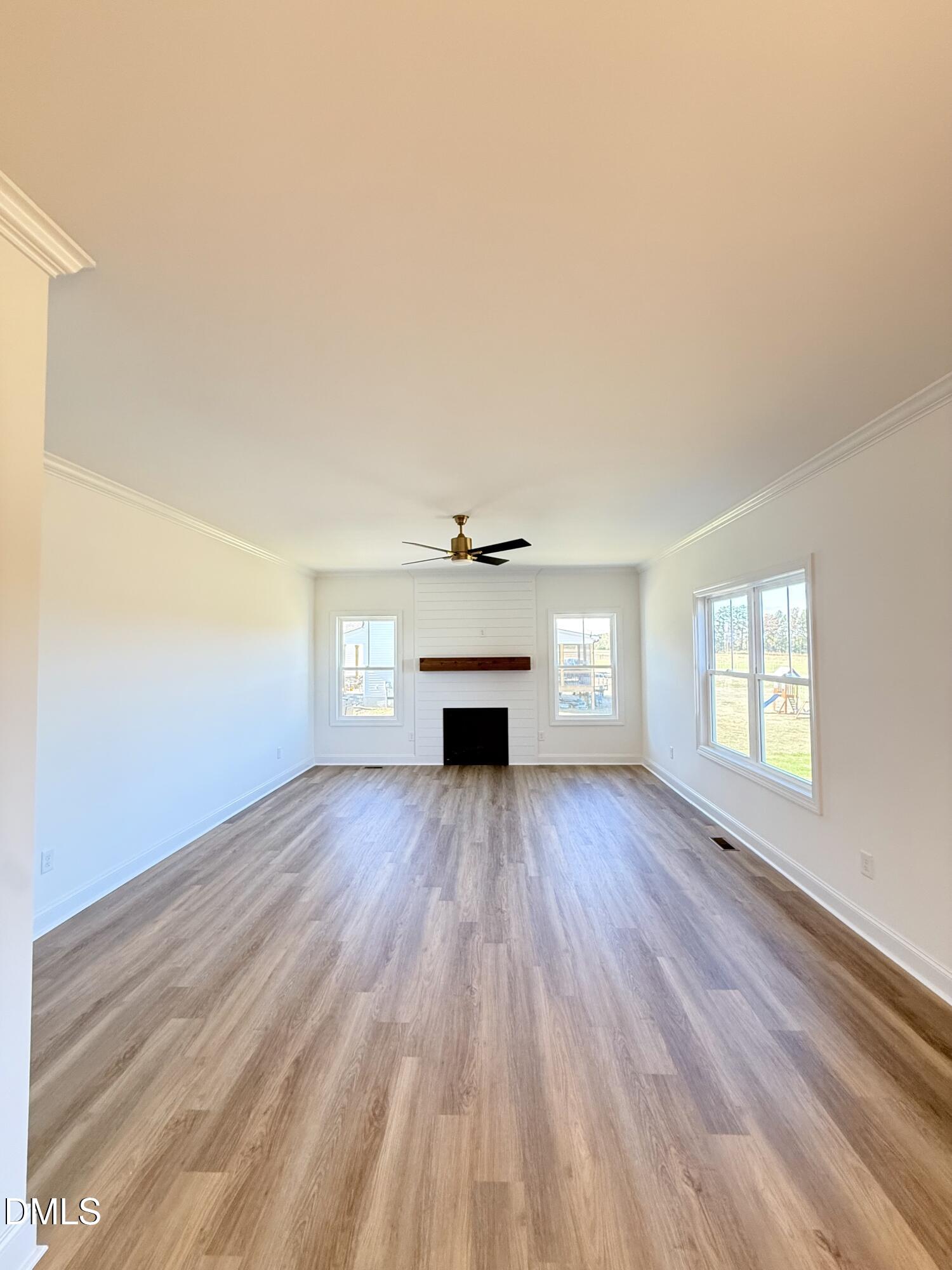 6800 Fire Tower Road Spring Hope, NC 27882 - Photo 15 of 36 wooden floor in an empty room with a window