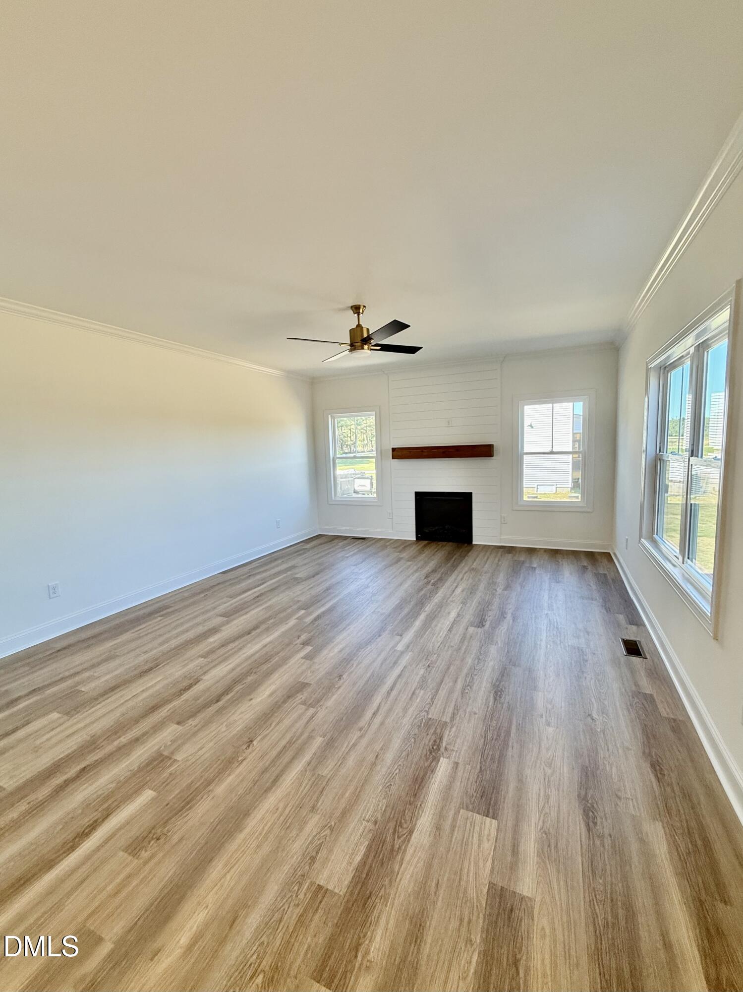 6800 Fire Tower Road Spring Hope, NC 27882 - Photo 16 of 36 wooden floor in an empty room with a window