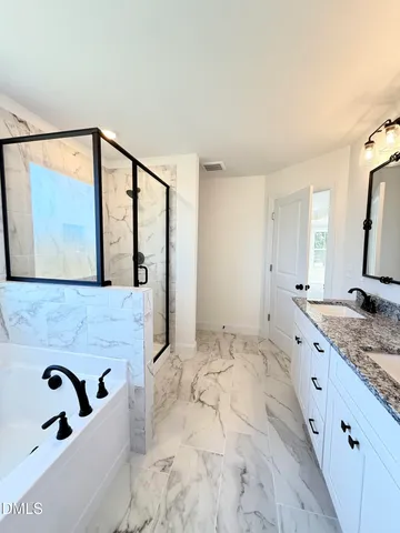 a bathroom with a bathtub and a shower