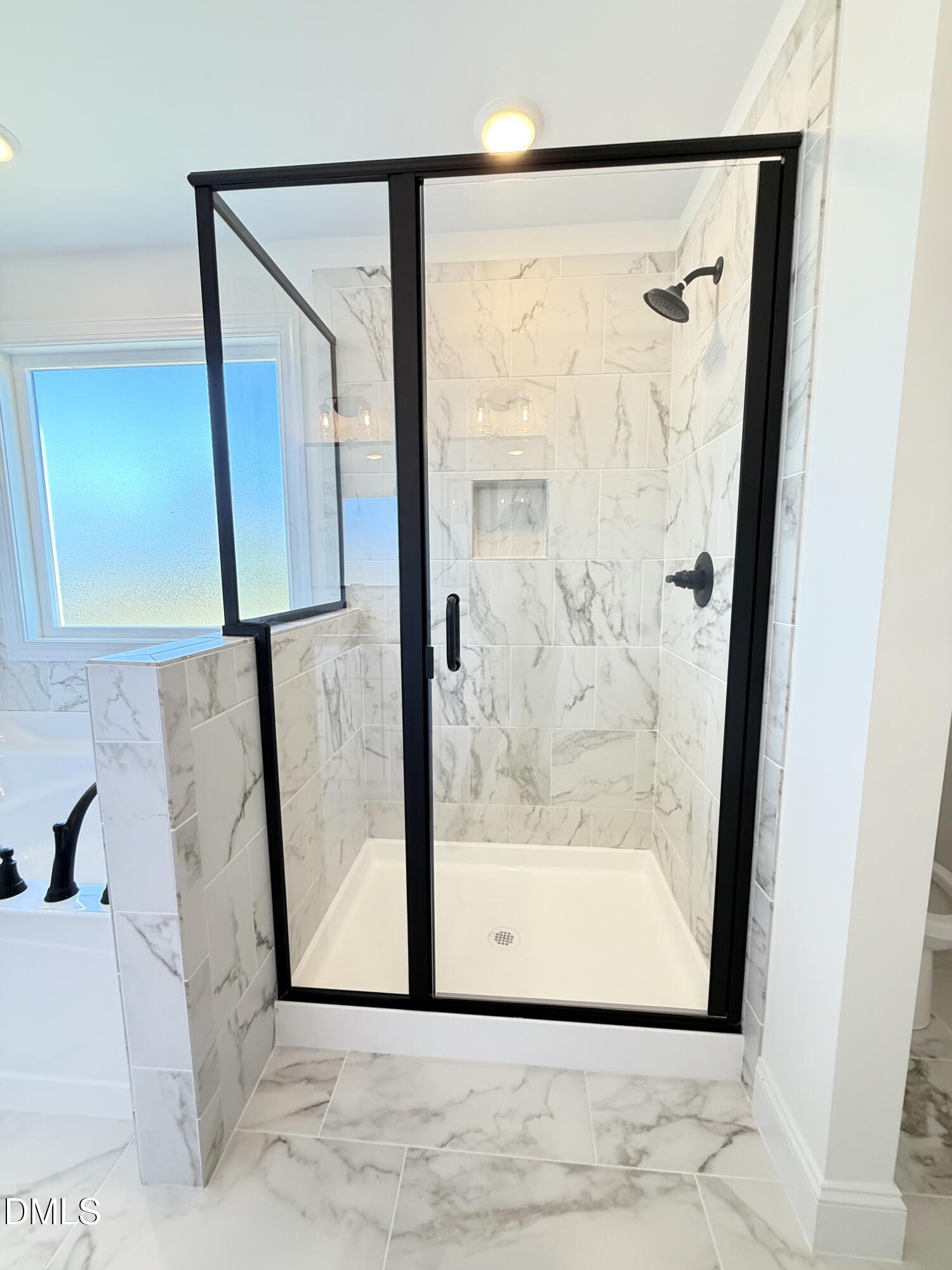 6800 Fire Tower Road Spring Hope, NC 27882 - Photo 25 of 36 a bathroom with a glass shower door and a window