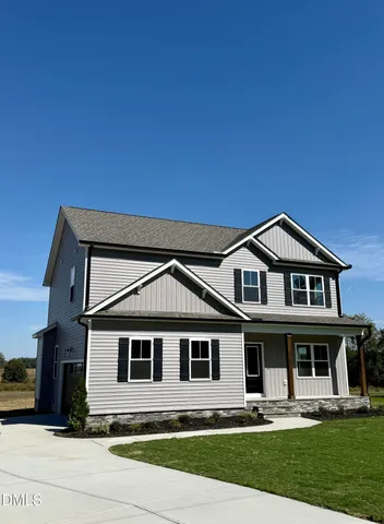a view of a patio with a table and chairs under wooden roof with potted plants