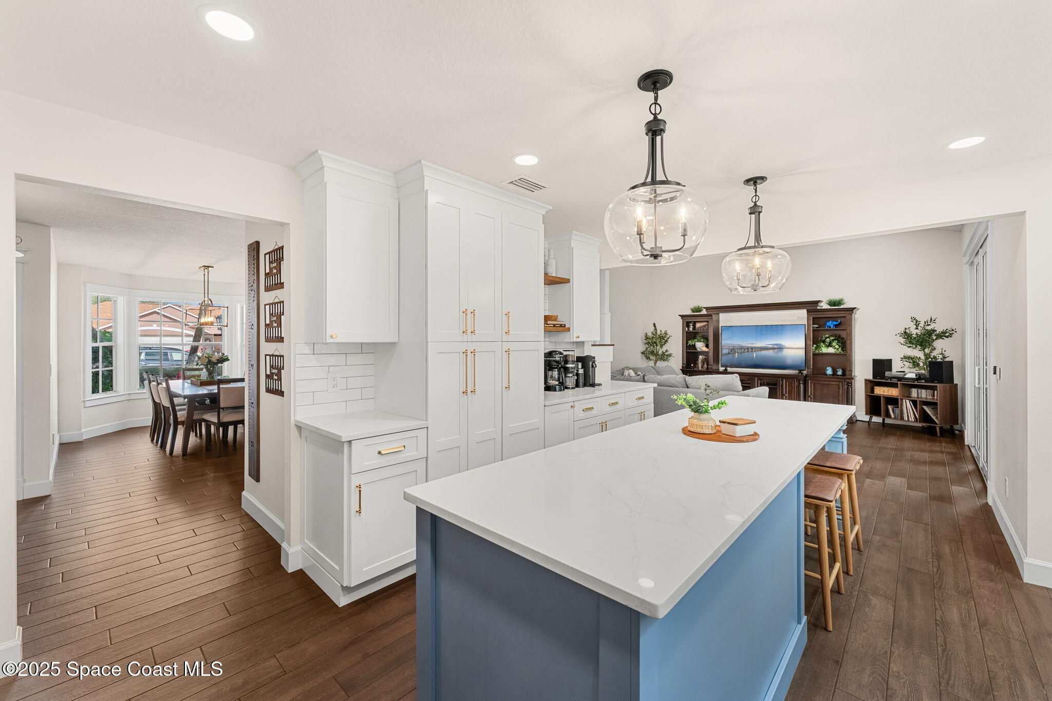 2525 Forest Run Drive Melbourne, FL 32935 - Photo 11 of 36 a large kitchen with white cabinets and stainless steel appliances