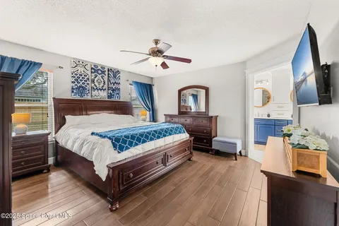 a bedroom with a bed wooden floor and window