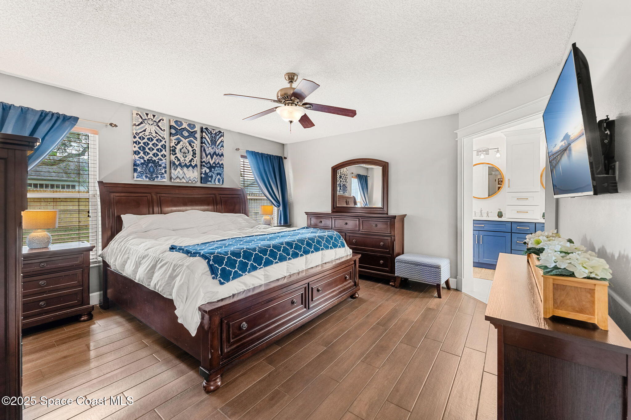 2525 Forest Run Drive Melbourne, FL 32935 - Photo 15 of 36 a bedroom with a bed wooden floor and window