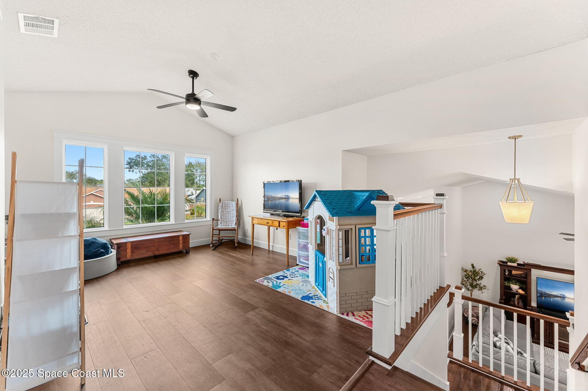 2525 Forest Run Drive Melbourne, FL 32935 - Photo 20 of 36 a view of a livingroom with furniture and a ceiling fan