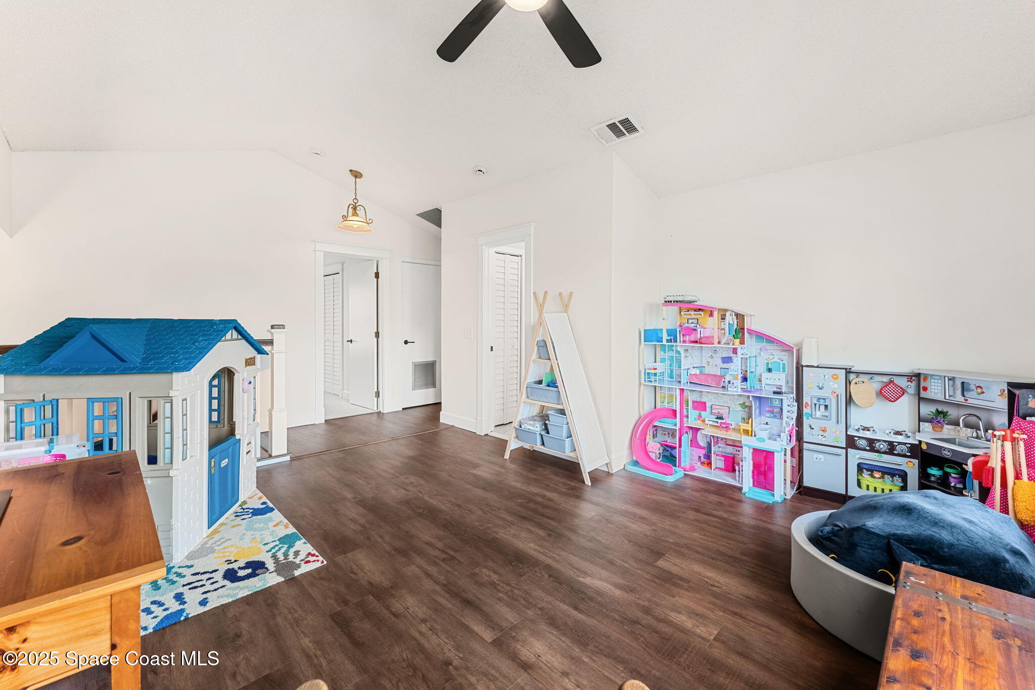 2525 Forest Run Drive Melbourne, FL 32935 - Photo 21 of 36 a living room with furniture and a book shelf