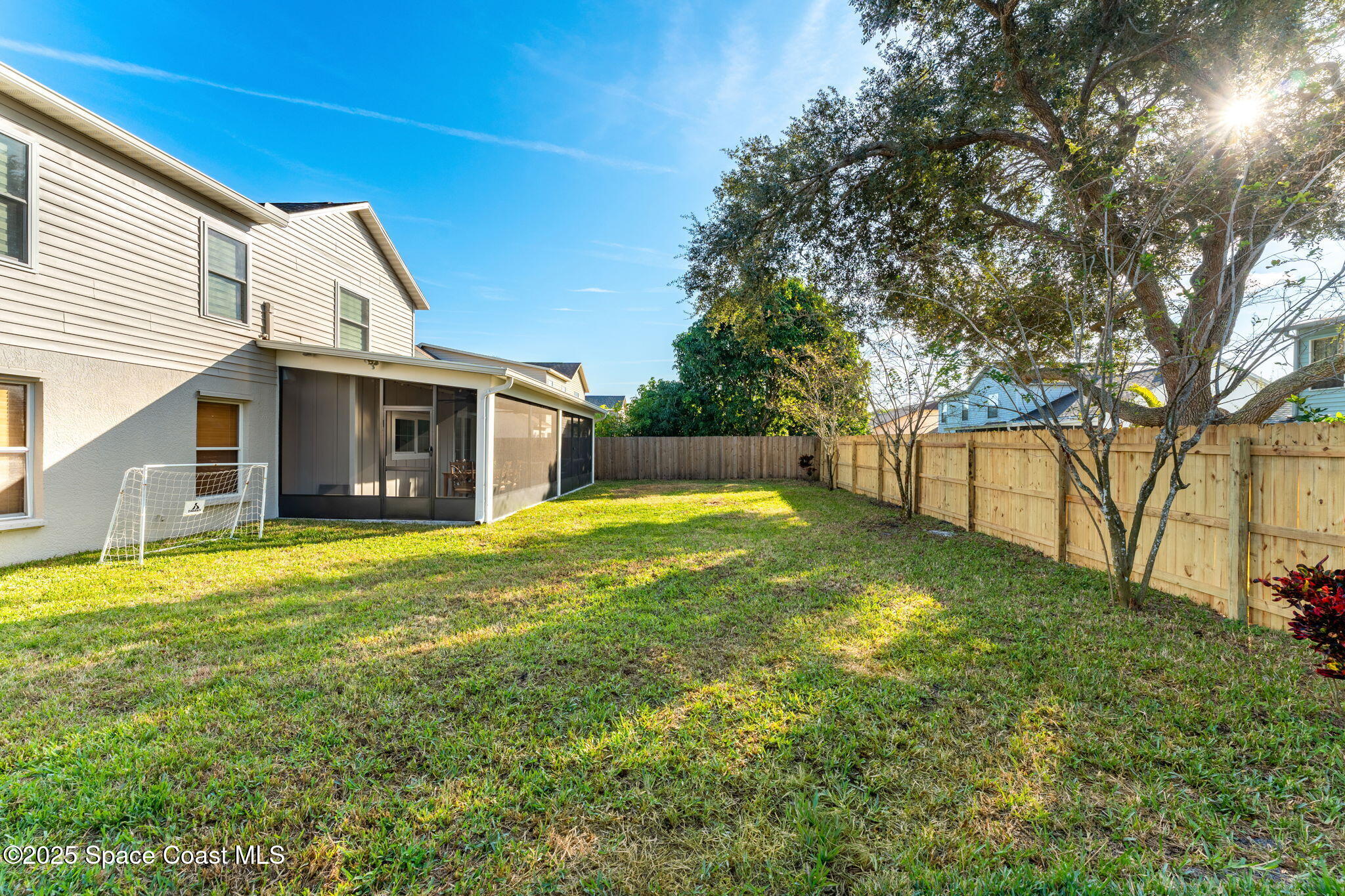 2525 Forest Run Drive Melbourne, FL 32935 - Photo 29 of 36 a view of a house with a backyard and a tree