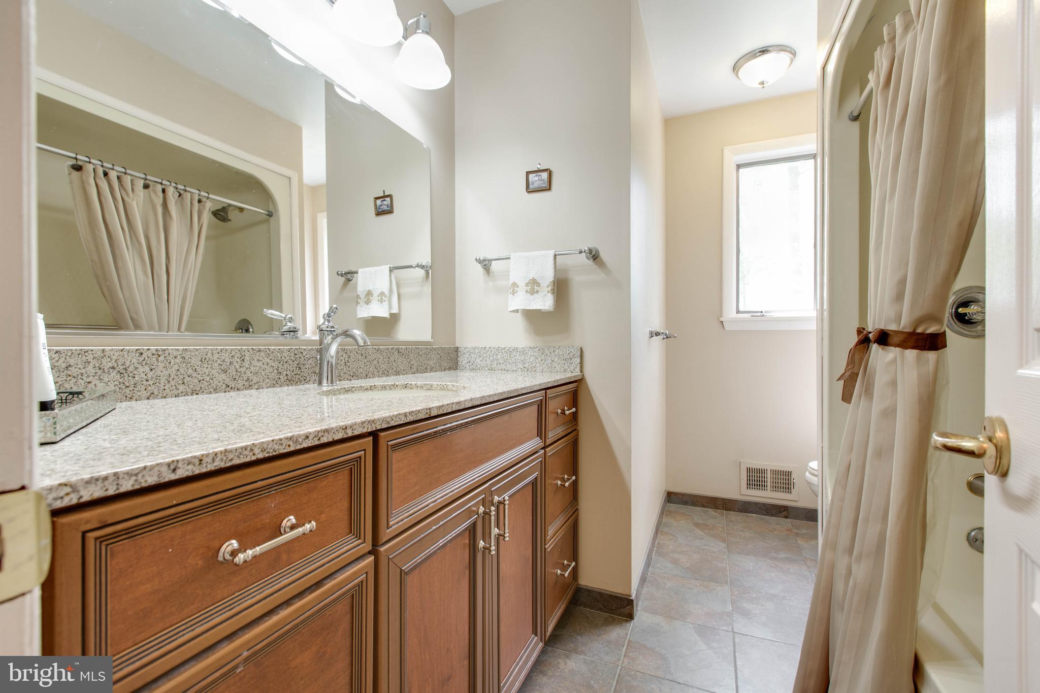 5519 Woodbine Road Sykesville, MD 21784 - Photo 30 of 69 a bathroom with a sink a vanity and a mirror