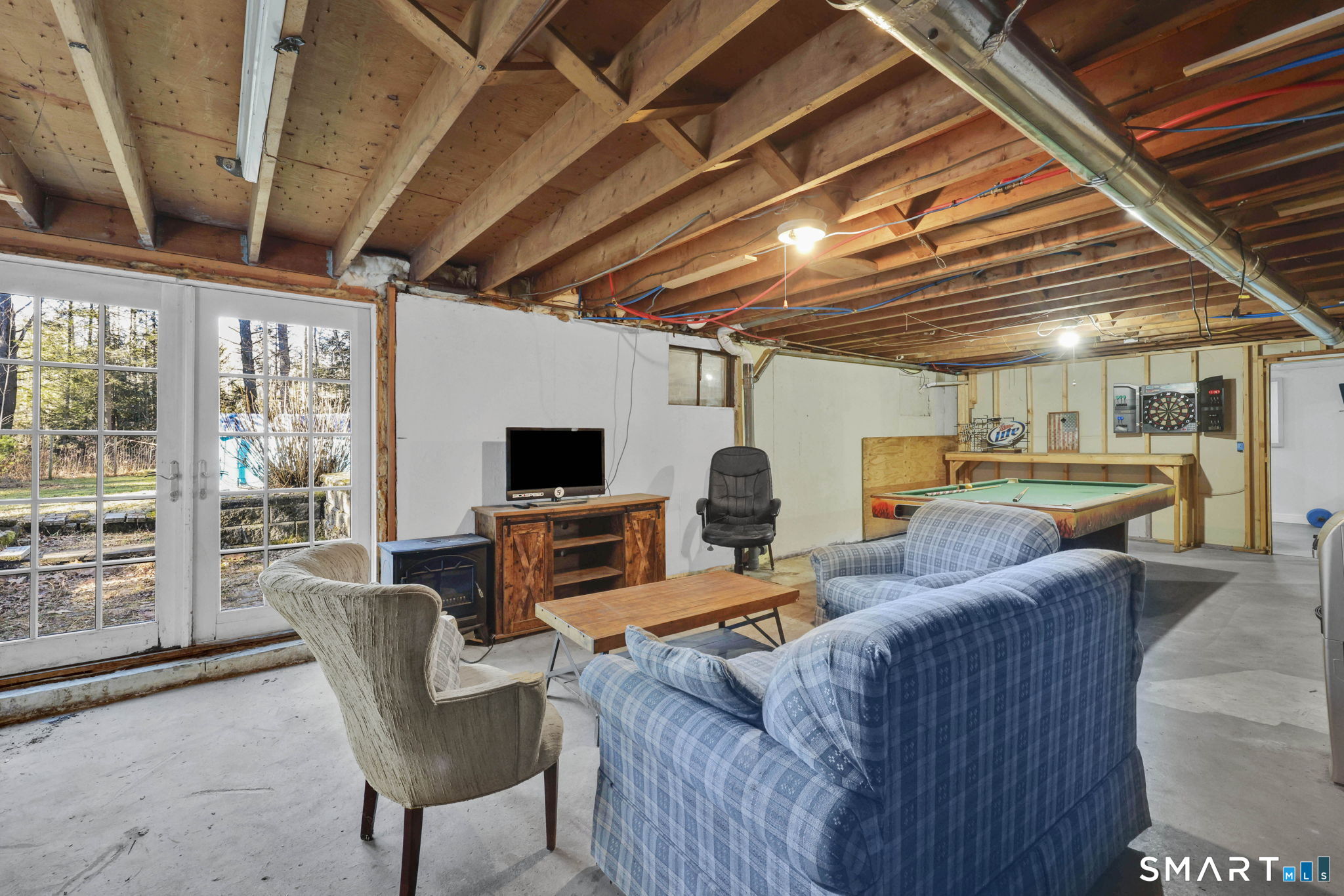 18 Racker Road Stafford, CT 06076 - Photo 25 of 38 a living room with furniture a flat screen tv and next to a window
