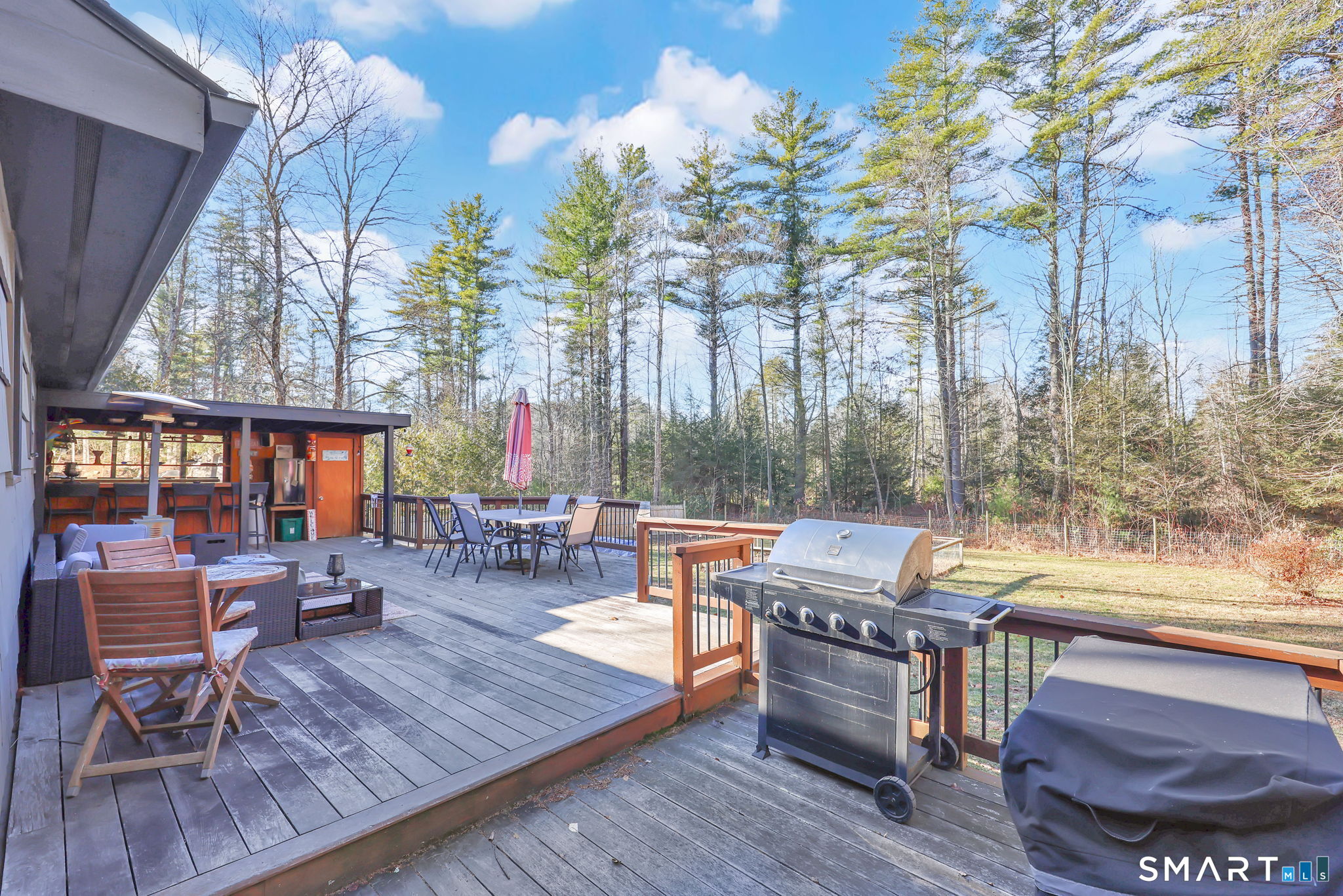 18 Racker Road Stafford, CT 06076 - Photo 34 of 38 a view of a patio with table and chairs potted plants and a large tree