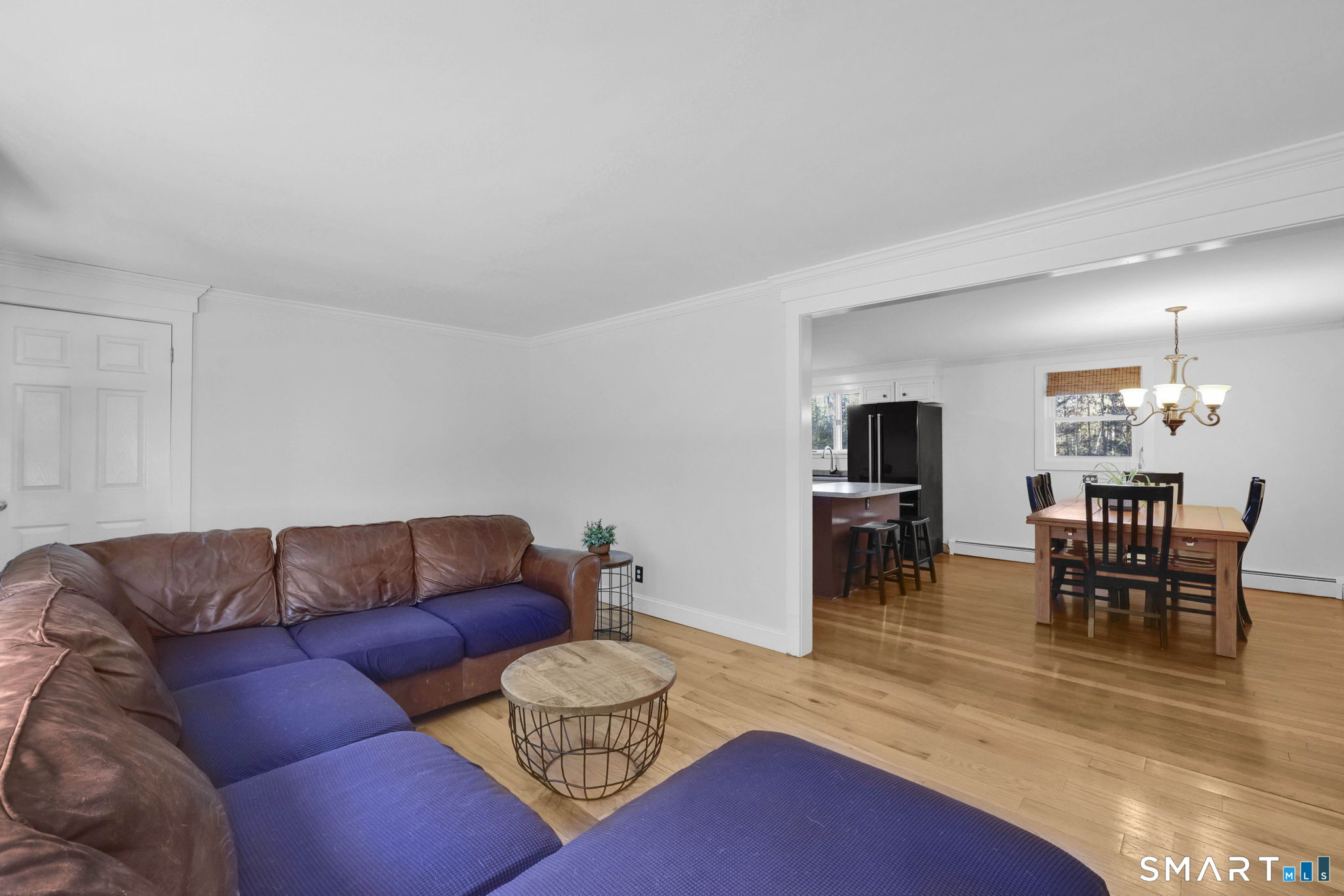 18 Racker Road Stafford, CT 06076 - Photo 4 of 38 a living room with furniture a dining table and kitchen view