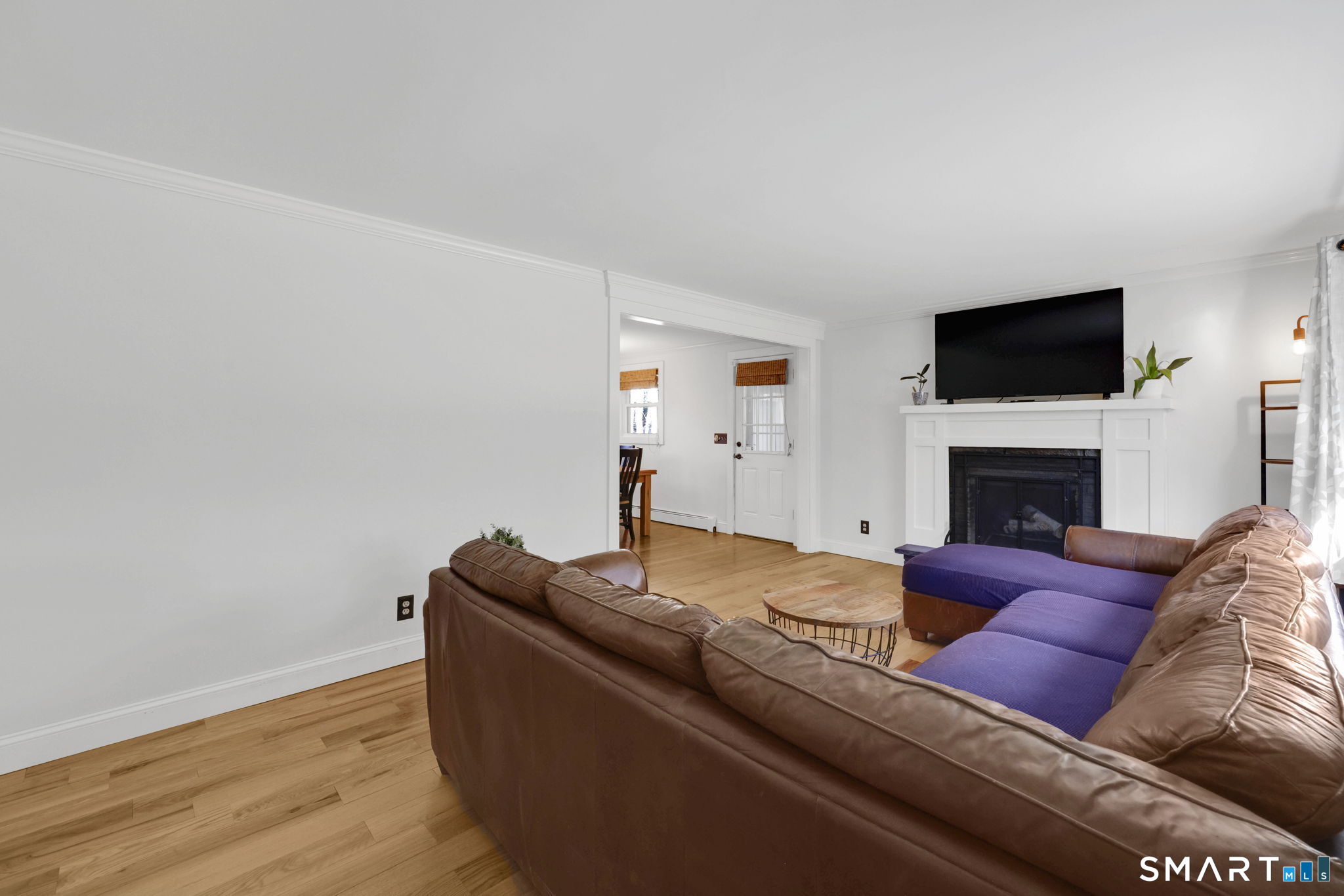 18 Racker Road Stafford, CT 06076 - Photo 5 of 38 a living room with furniture a flat screen tv and a fireplace