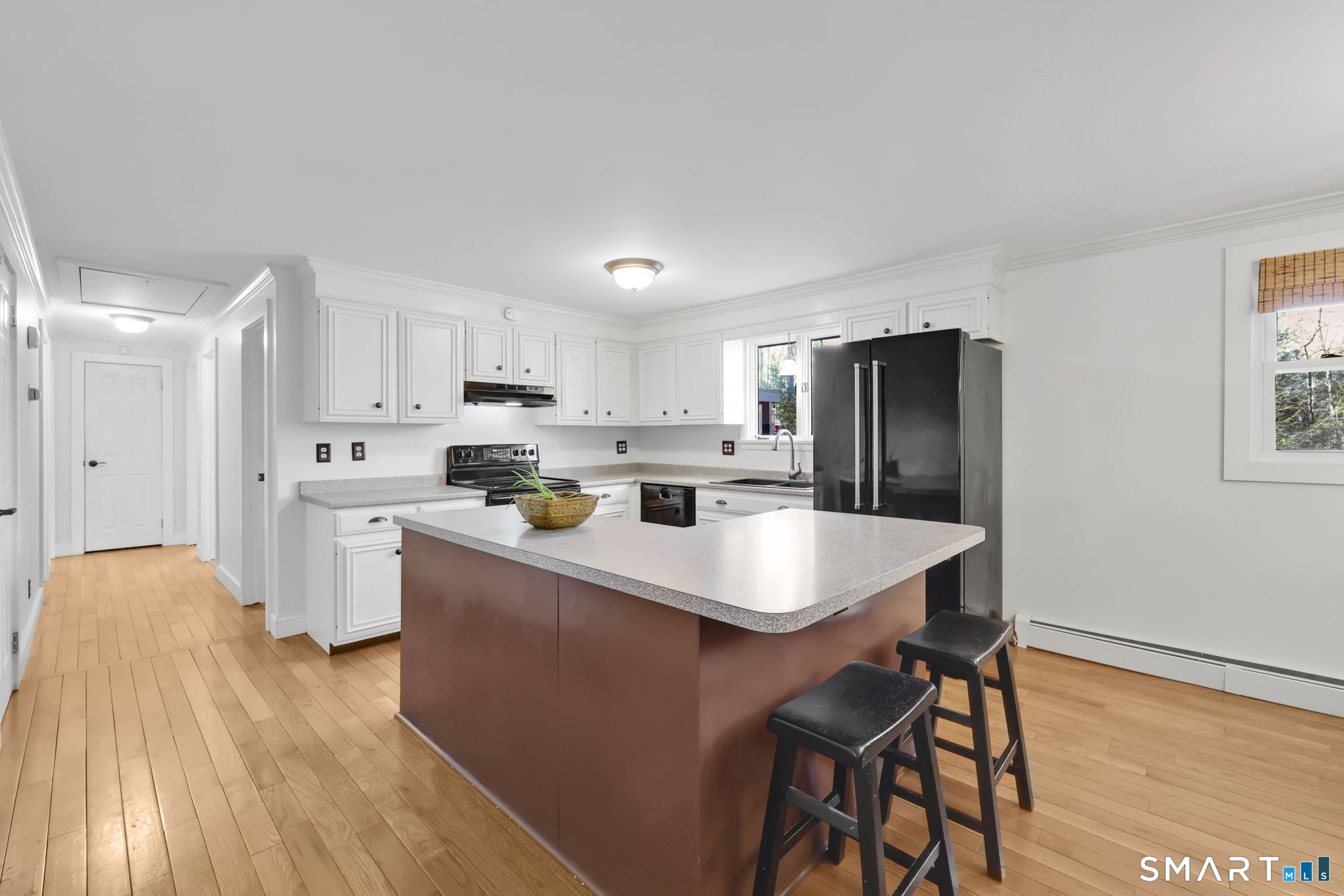 18 Racker Road Stafford, CT 06076 - Photo 6 of 38 a kitchen with stainless steel appliances a refrigerator a stove a sink dishwasher and a refrigerator with wooden floor