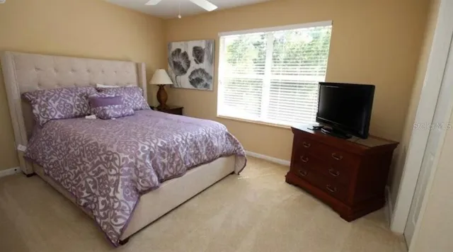 a bedroom with a bed and flat screen tv