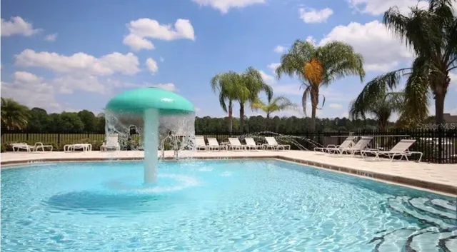 a view of a swimming pool and lounge chair