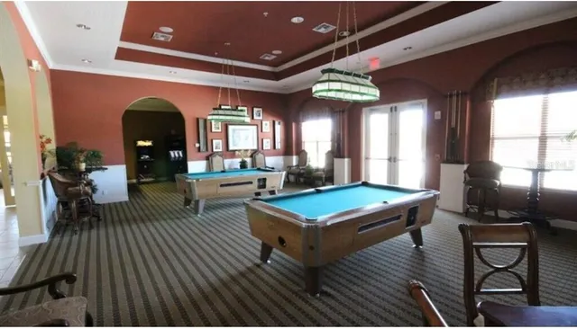 a living room with furniture a rug and a large window