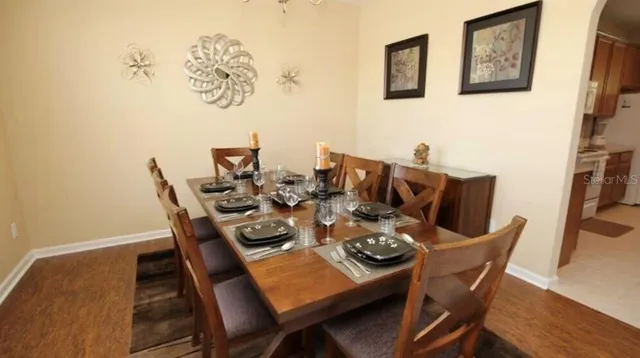 a dining room with furniture and wooden floor