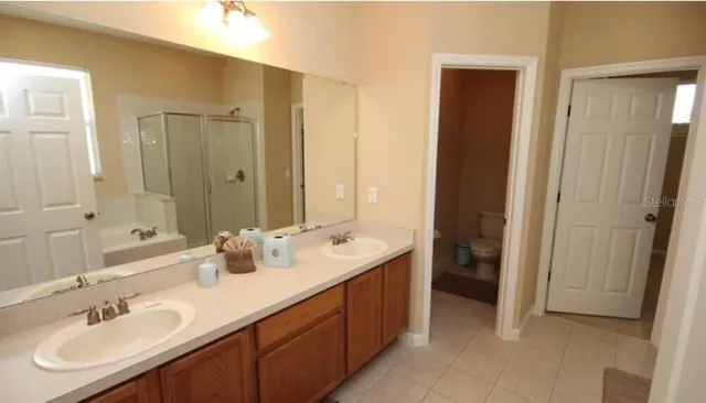 a bathroom with double sink and a mirror