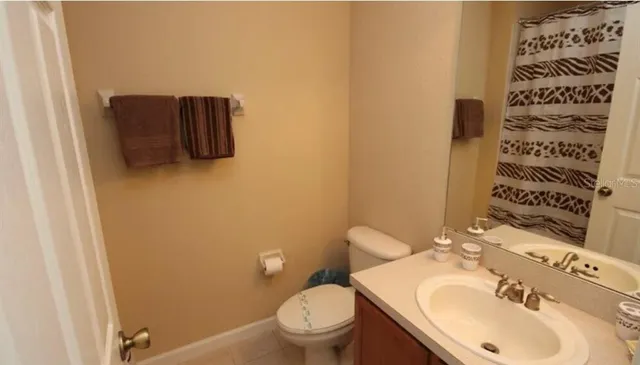 a bathroom with a sink toilet and mirror