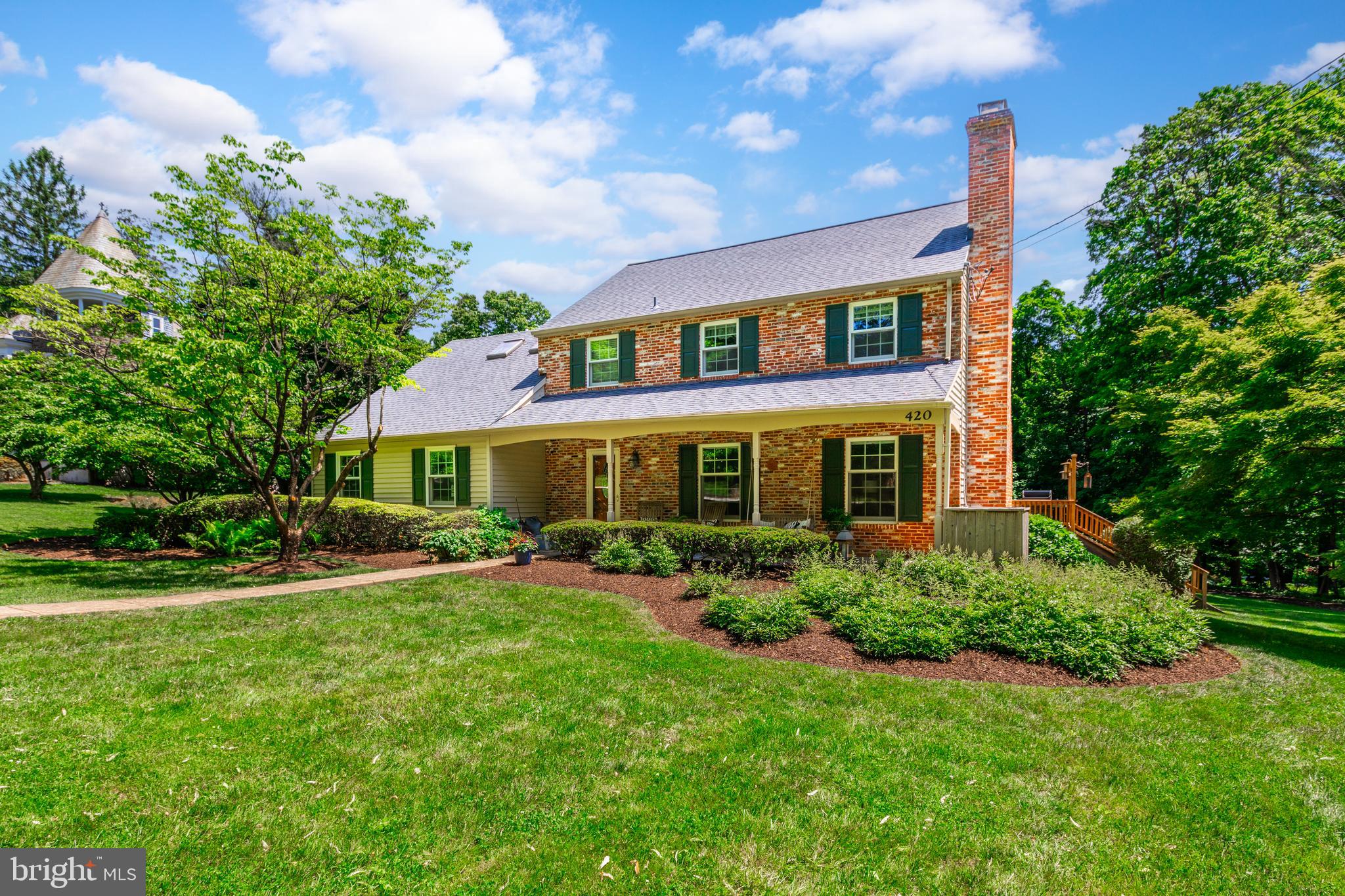 a front view of a house with a yard table and chairs