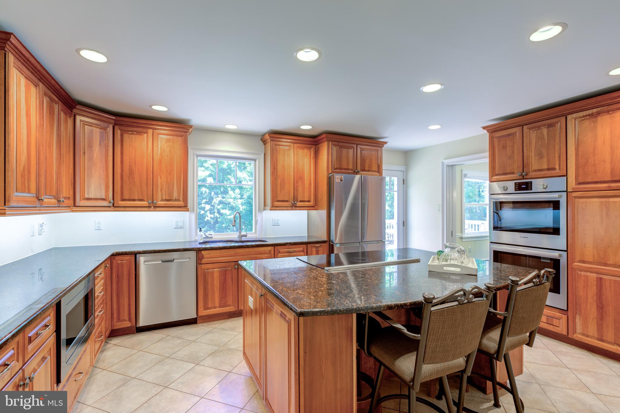 420 Accomac Road Wyncote, PA 19095 - Photo 19 of 82 a kitchen with granite countertop a table chairs microwave and cabinets