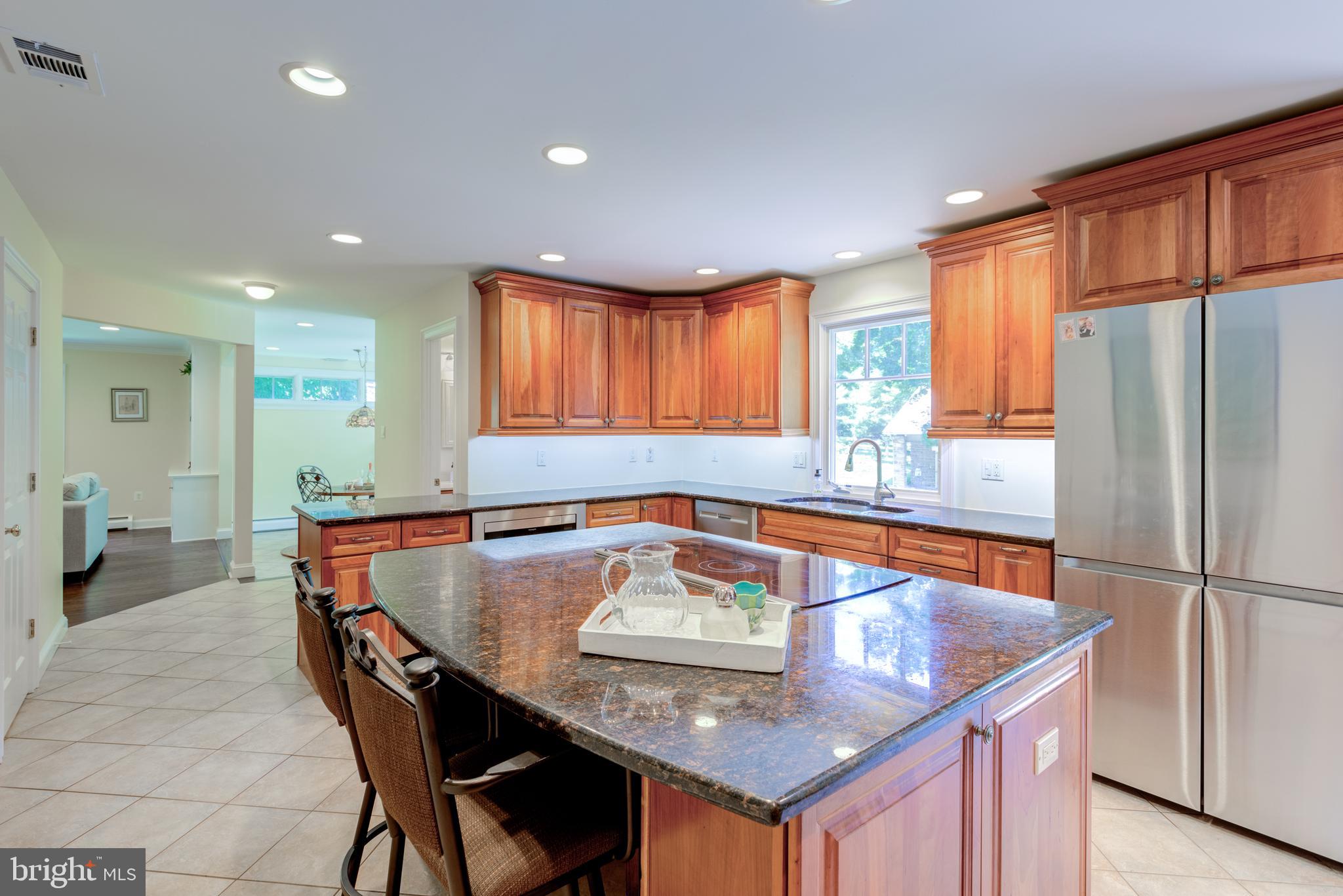 420 Accomac Road Wyncote, PA 19095 - Photo 20 of 82 a kitchen with stainless steel appliances granite countertop a sink a table and chairs