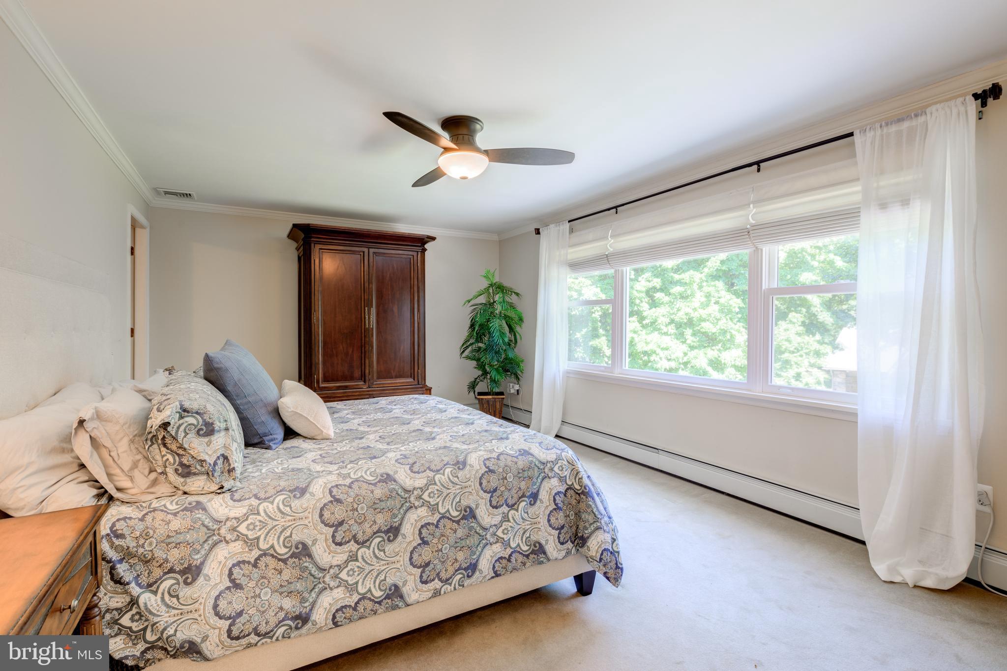 420 Accomac Road Wyncote, PA 19095 - Photo 32 of 82 a bedroom with a large bed and a large window