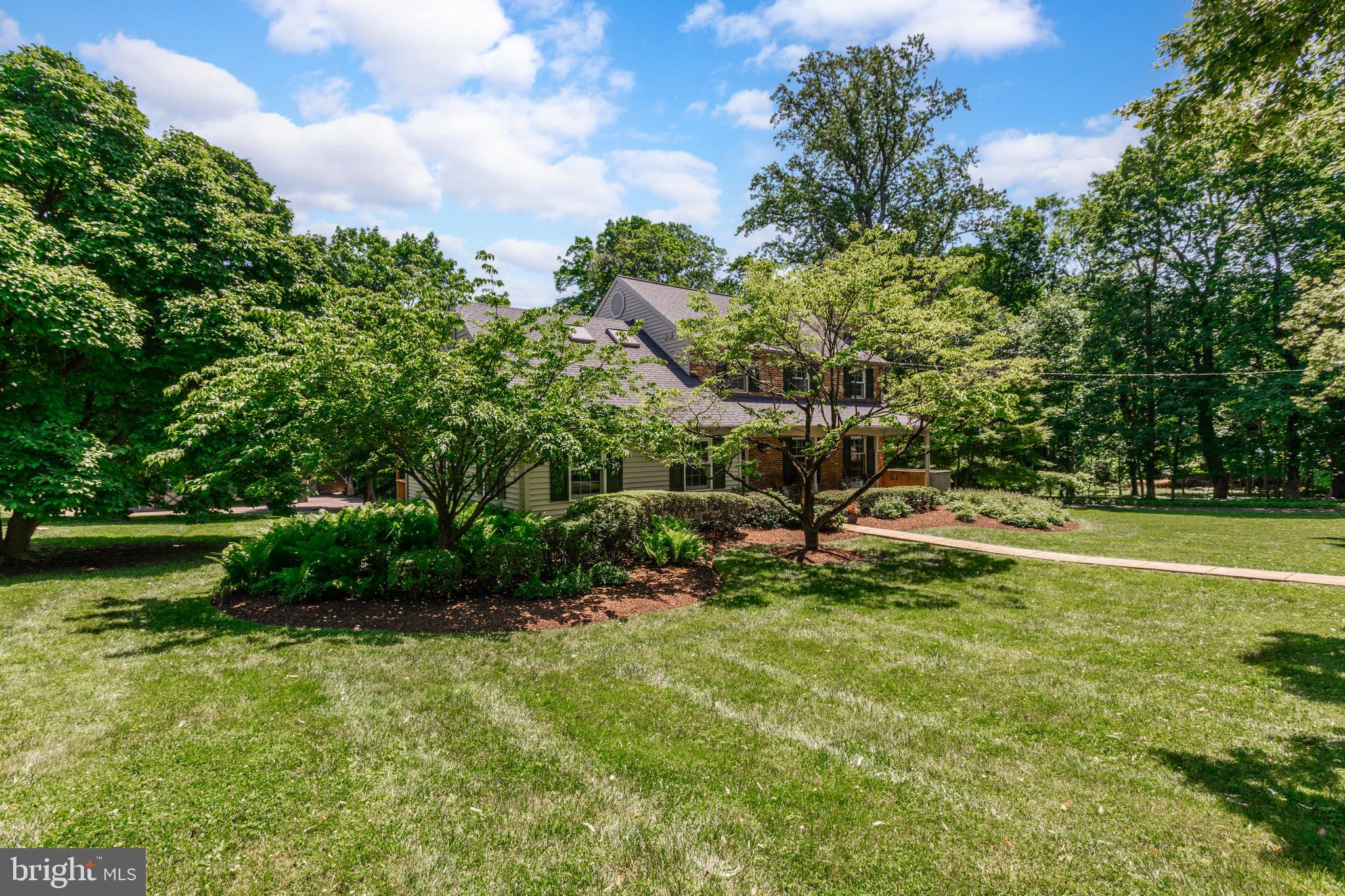 420 Accomac Road Wyncote, PA 19095 - Photo 4 of 82 a view of a garden with a bench in the background