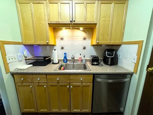 a kitchen with stainless steel appliances wooden cabinets and a sink