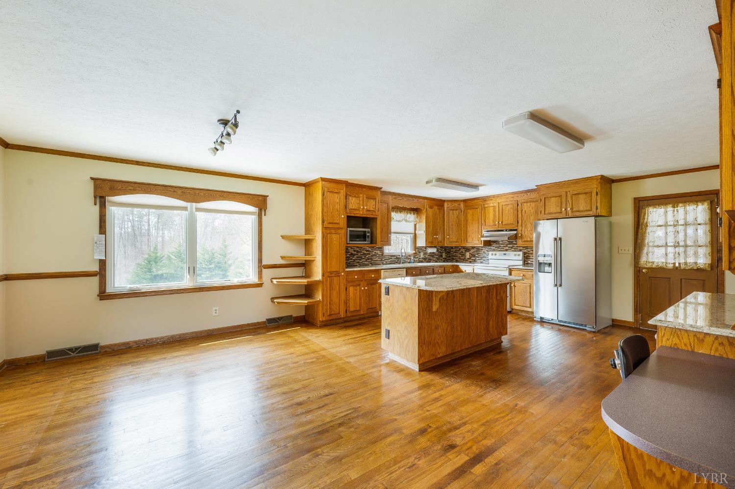 129 Quail Ridge Drive Altavista, VA 24517 - Photo 11 of 76 a large kitchen with stainless steel appliances granite countertop a stove a sink and a refrigerator