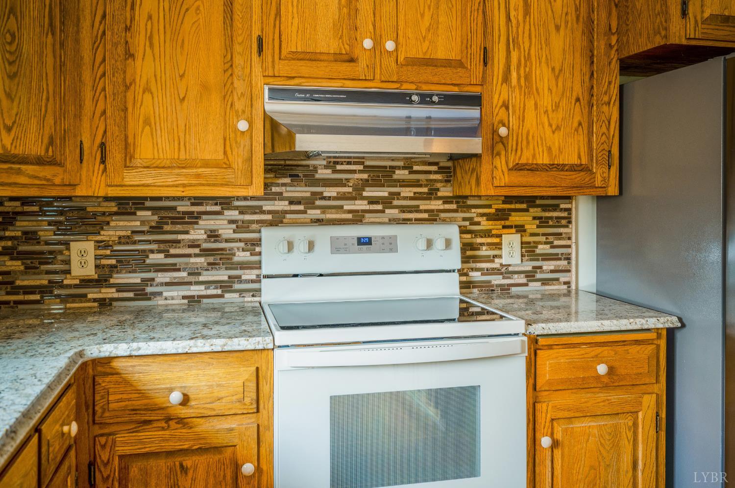 129 Quail Ridge Drive Altavista, VA 24517 - Photo 14 of 76 a stove top oven sitting inside of a kitchen