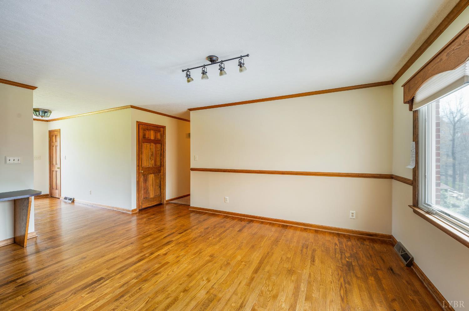 129 Quail Ridge Drive Altavista, VA 24517 - Photo 17 of 76 a view of an empty room with wooden floor and a window