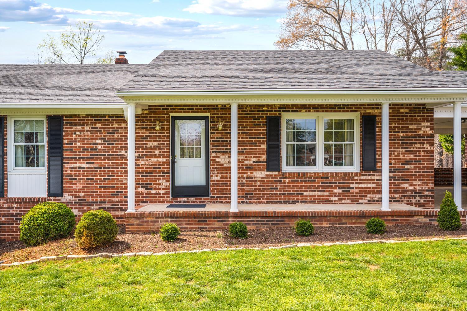 129 Quail Ridge Drive Altavista, VA 24517 - Photo 2 of 76 front view of a brick house with a yard