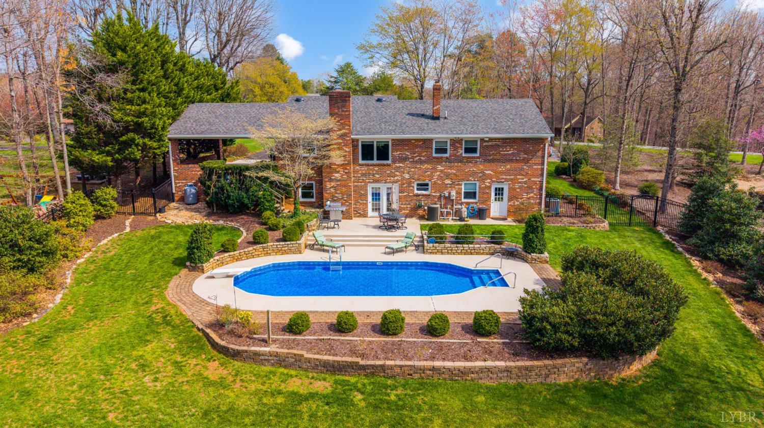 129 Quail Ridge Drive Altavista, VA 24517 - Photo 50 of 76 a view of a house with swimming pool and garden