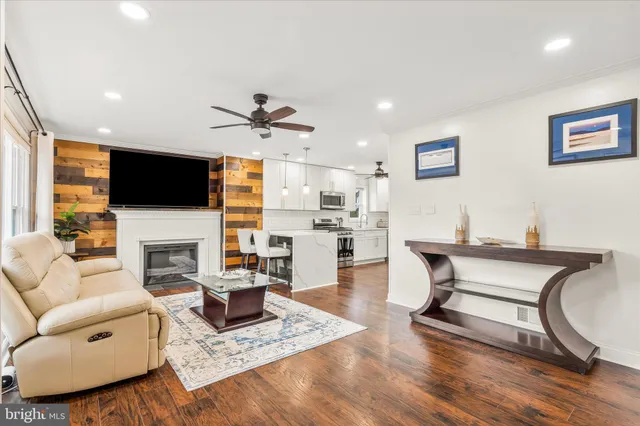 a living room with fireplace furniture and a flat screen tv