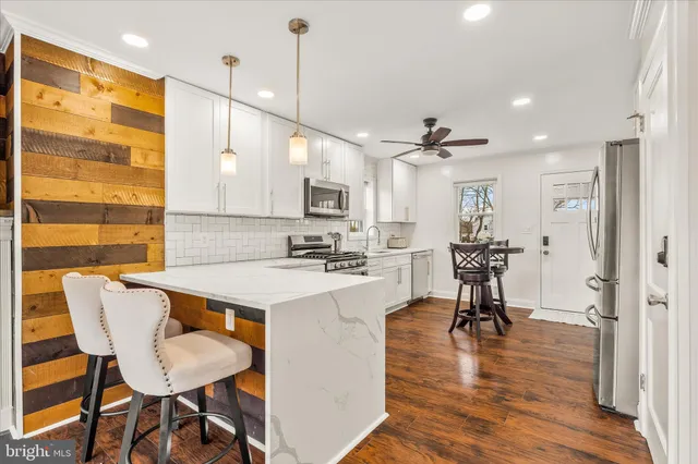 a view of kitchen with cabinets and wooden floor