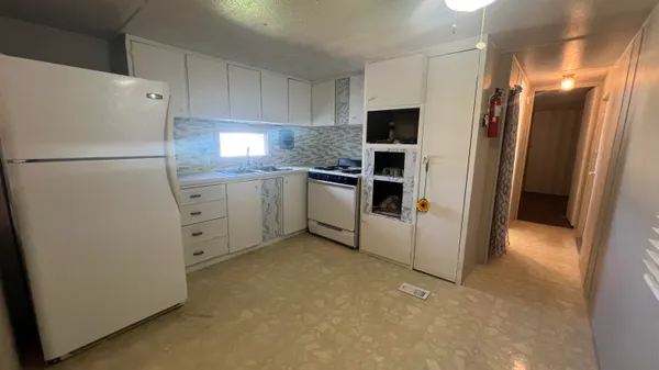 a kitchen with cabinets and stainless steel appliances
