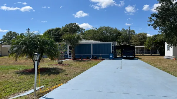 a house view with a backyard space