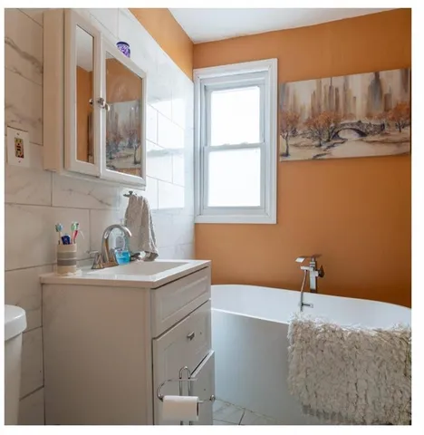 a bathroom with a sink and a window