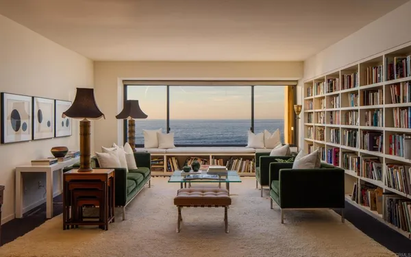 a living room with furniture and a bookshelf
