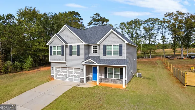 a front view of a house with a garden