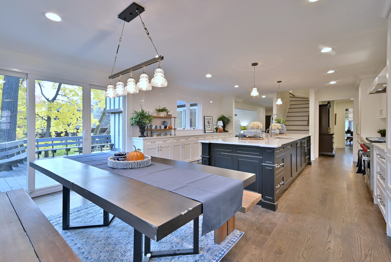 13 Woodgate Drive Burr Ridge, IL 60527 - Photo 16 of 46 a open dining room with stainless steel appliances kitchen island granite countertop a table chairs and a living room