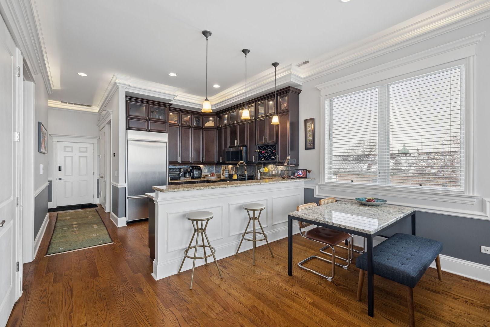 3420 South Morgan Street, Unit 4E Chicago, IL 60608 - Photo 6 of 24 a living room with stainless steel appliances kitchen island granite countertop furniture and a wooden floor