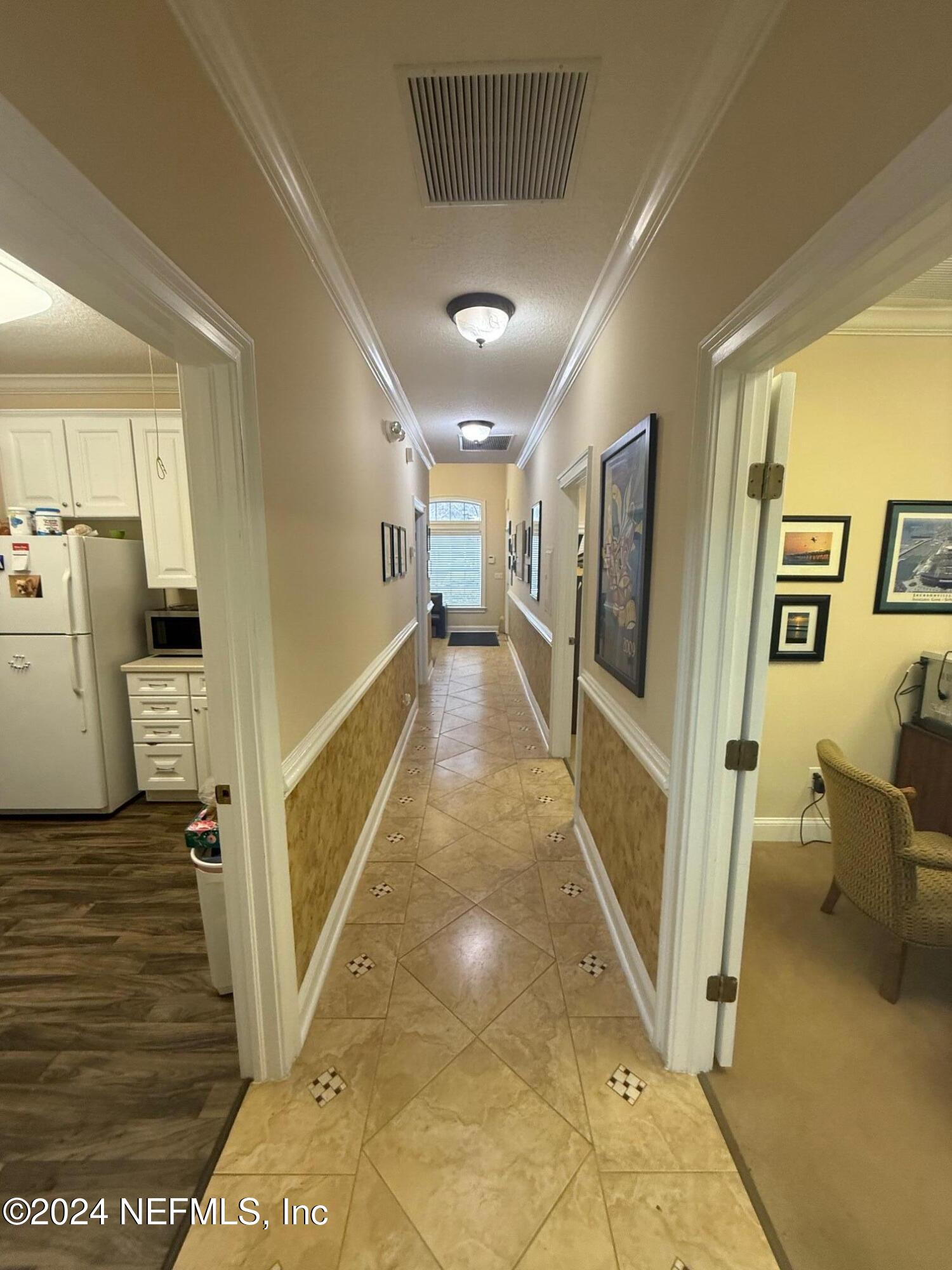 9310 Old Kings Road South, Unit 1101 Jacksonville, FL 32257 - Photo 12 of 13 a view of a hallway with a couch