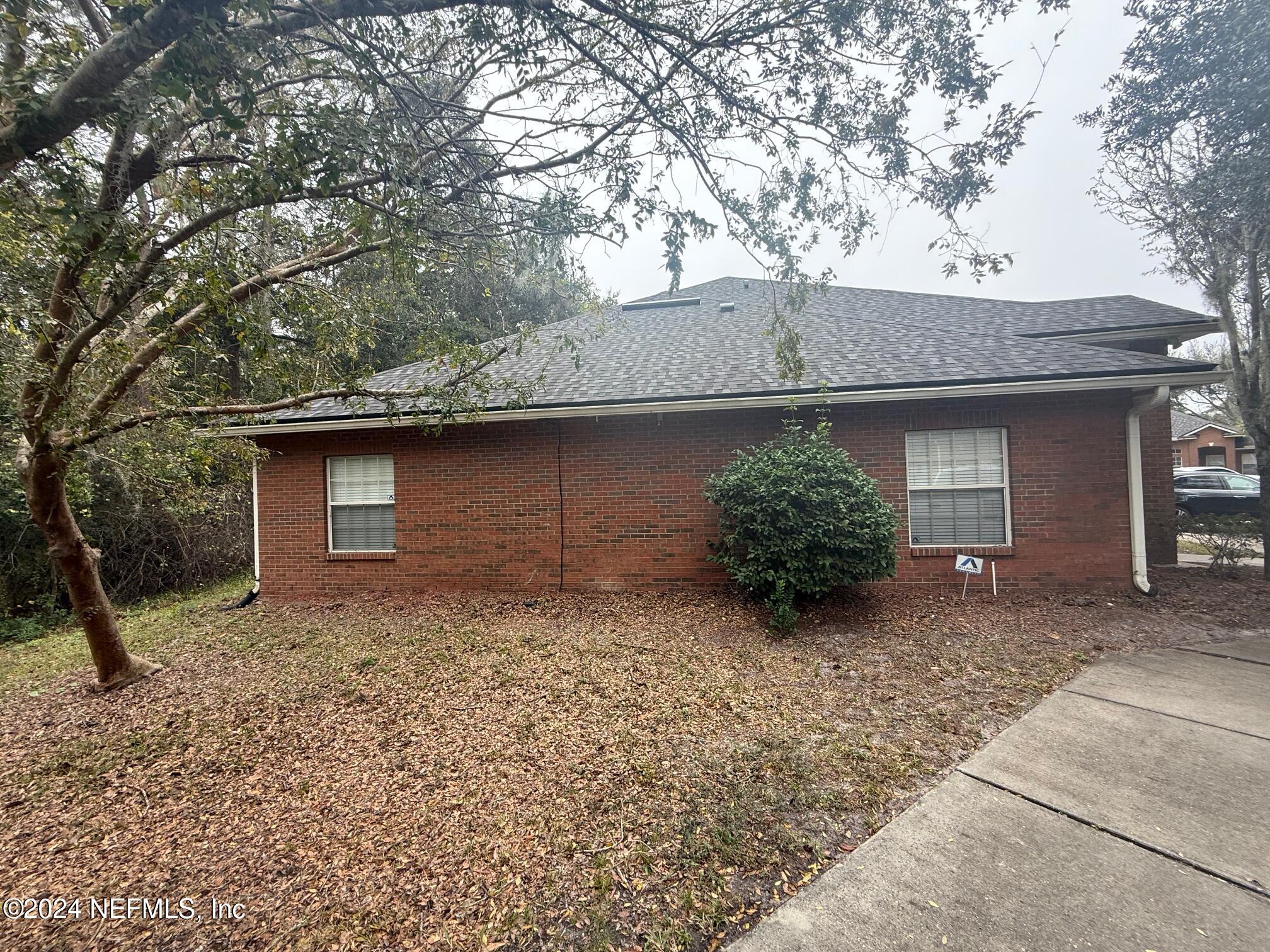 9310 Old Kings Road South, Unit 1101 Jacksonville, FL 32257 - Photo 2 of 13 a view of a house with large tree and a yard