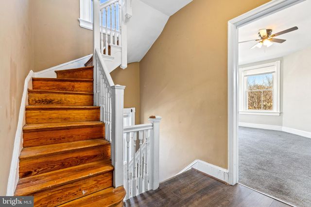 a view of a livingroom with a ceiling fan and window