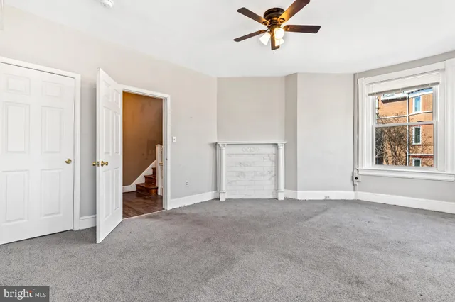 an empty room with fan and window