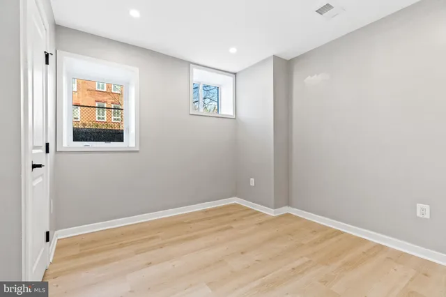 a bathroom with a toilet sink shower and mirror