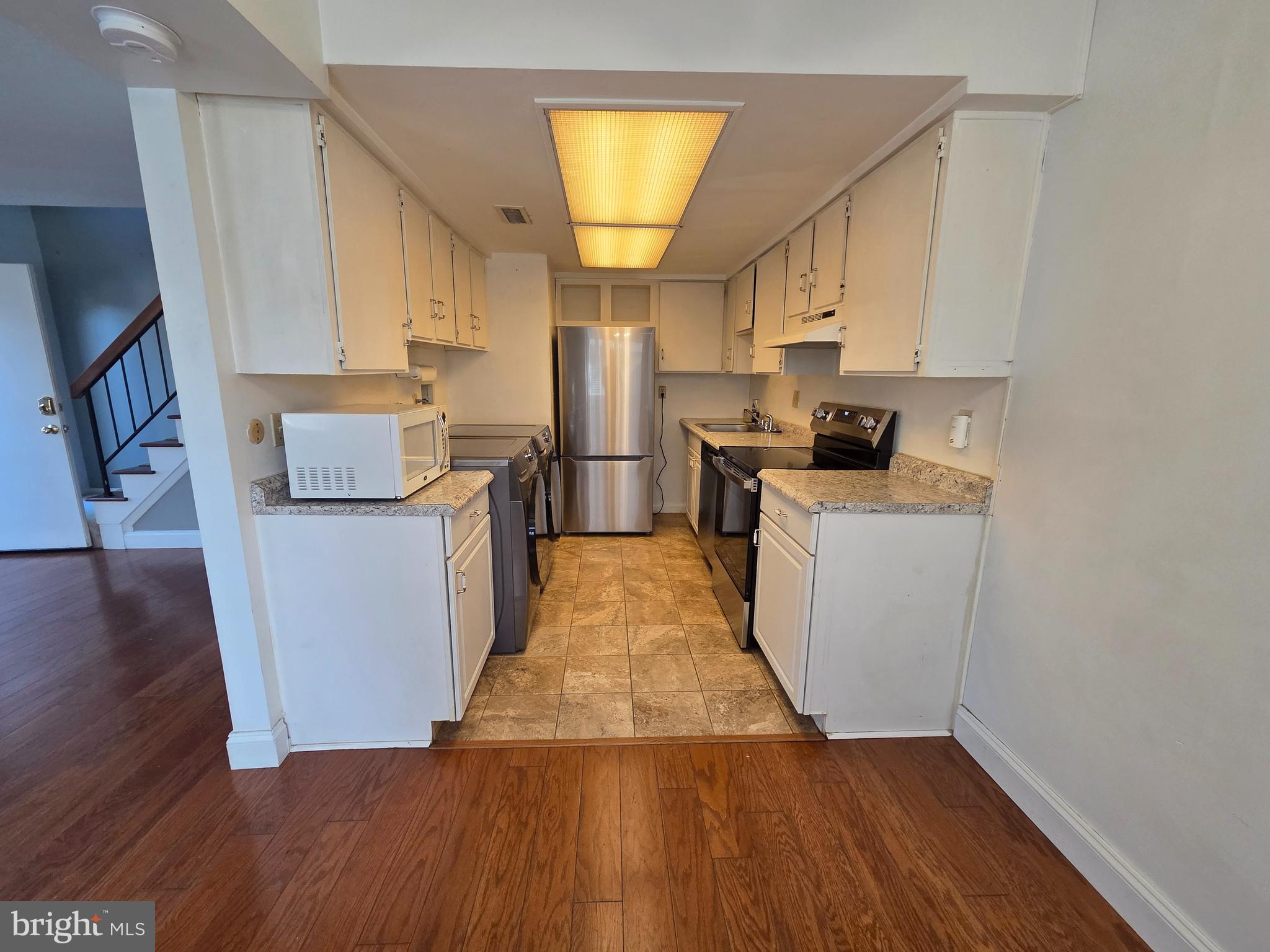 1729 Leisure Way Crofton, MD 21114 - Photo 13 of 20 a kitchen with a sink a refrigerator and cabinets