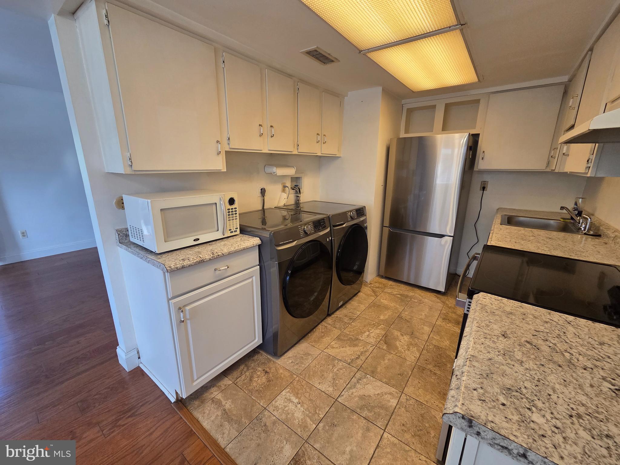 1729 Leisure Way Crofton, MD 21114 - Photo 14 of 20 a kitchen with a refrigerator sink and wooden cabinets